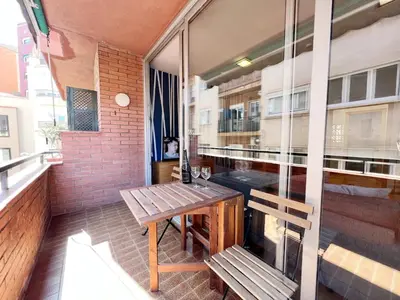 a balcony with a wooden table and benches on a building at Gracia Village Barcelona in Barcelona