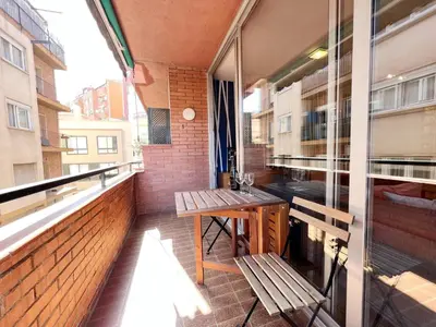 a balcony with benches and a table on a building at Gracia Village Barcelona in Barcelona