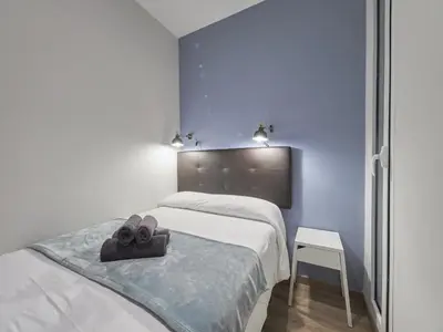 a bedroom with a bed with a hat on it at Gran Via Terrace Barcelona in Barcelona
