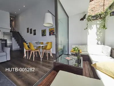 a living room with a couch and a table at Loft Miro Apart Barcelona in Barcelona