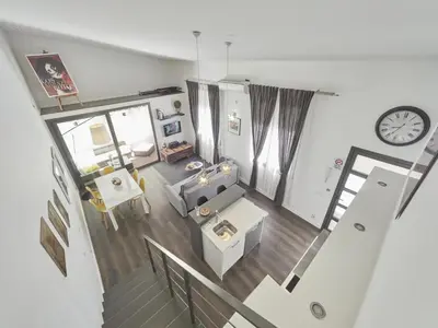an overhead view of a living room with a clock at Loft Miro Apart Barcelona in Barcelona