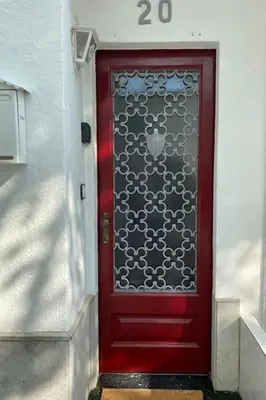 a red door with a number on it at Casita pueblo al lado Del Mar-Vilasardemarlux4 in Vilassar de Mar