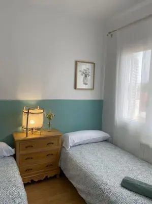 a bedroom with two beds and a dresser and a window at Casita pueblo al lado Del Mar-Vilasardemarlux4 in Vilassar de Mar