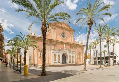 a building with palm trees in front of it at Nice Central Loft in Vilanova i la Geltrú