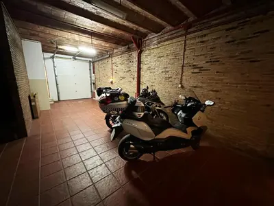 a row of motorcycles parked in a room with a brick wall at CASA NEUS, Casa única cerca de Barcelona in Sant Feliu de Llobregat