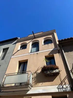 a tall building with windows and a balcony at CASA NEUS, Casa única cerca de Barcelona in Sant Feliu de Llobregat