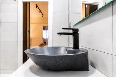 a sink with a faucet on a counter in a bathroom at Exclusive Apartments Barcelona 4 personas St Pere in Terrassa
