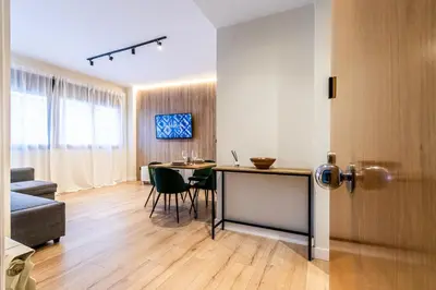 a living room with a table and a dining room at Exclusive Apartments Barcelona 4 personas St Pere in Terrassa