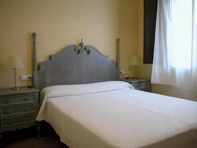 a bedroom with a large white bed with two night stands at APARTAMENTS PUIG GILI in Mura