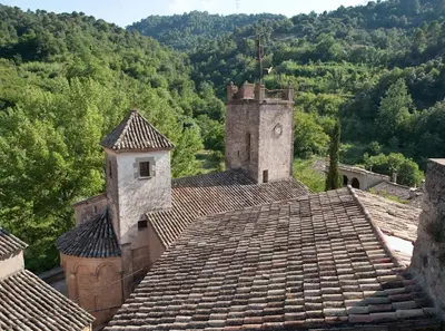 an old building with a clock tower on top of a roof at APARTAMENTS PUIG GILI in Mura