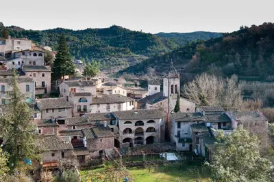 a village in the mountains with a church at APARTAMENTS PUIG GILI in Mura