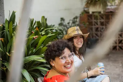 two women sitting next to each other in front of plants at Leevin Student Barcelona in Barcelona