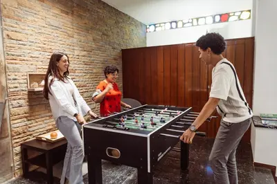 a group of people playing with a foosball table at Leevin Student Barcelona in Barcelona