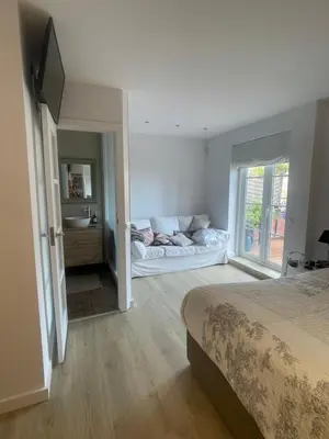 a bedroom with a bed and a sink and a mirror at Wonderful house near Barcelona in Castelldefels