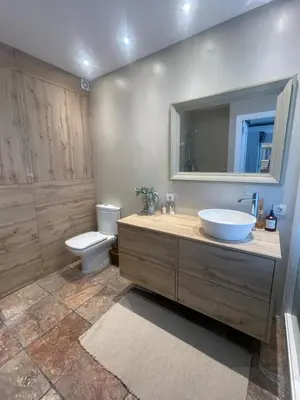 a bathroom with a sink and a toilet and a mirror at Wonderful house near Barcelona in Castelldefels