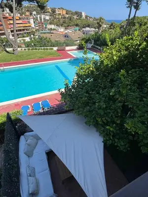 a view of a swimming pool with a couch and chairs at Wonderful house near Barcelona in Castelldefels