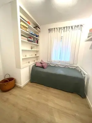 a bedroom with a green bed and a window at Wonderful house near Barcelona in Castelldefels