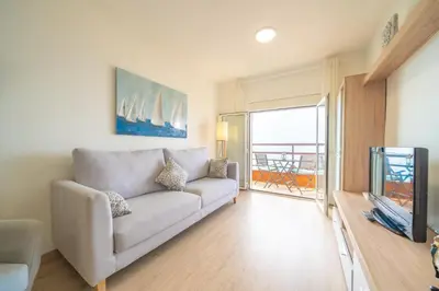 a living room with a couch and a television at HomeHolidaysRentals Estrella - Costa Barcelona in Pineda de Mar