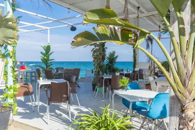 a restaurant with the ocean in the background at HomeHolidaysRentals Estrella - Costa Barcelona in Pineda de Mar