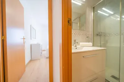 a bathroom with a sink and a glass shower at HomeHolidaysRentals Estrella - Costa Barcelona in Pineda de Mar