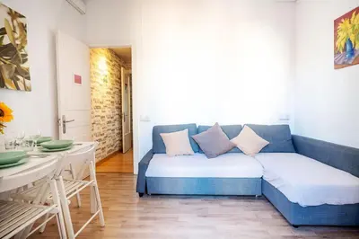 a living room with a blue couch and a table at Centric Apartments Sagrada Famila 3 in Barcelona