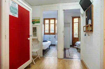 a red door in a room with a bedroom at Centric Apartments Sagrada Famila 3 in Barcelona