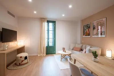 a living room with a couch and a table at CATERINA Sant Pau in Barcelona