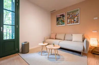 a living room with a couch and two tables at CATERINA Sant Pau in Barcelona