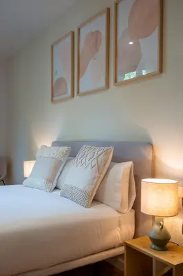 a bedroom with a bed with pillows on it at CATERINA Sant Pau in Barcelona