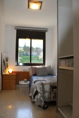 a bedroom with a bed and a window at Barcelo al riu in Monistrol