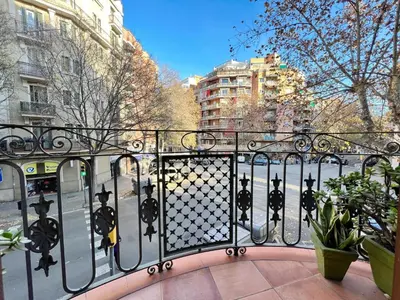a gate to a balcony in a city with buildings at Suite Miro Eixample Barcelona in Barcelona