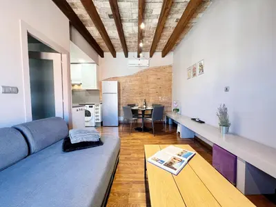 a living room with a couch and a table at Suite Gracia Barcelona in Barcelona
