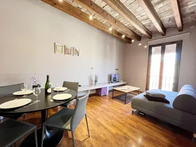 a living room with a table and a couch at Suite Gracia Barcelona in Barcelona