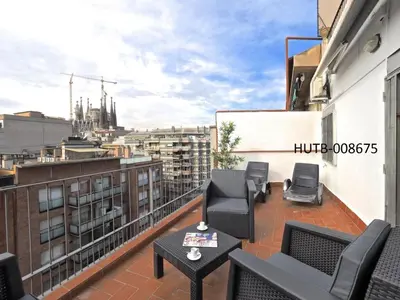 a balcony with chairs and a table on a building at Sagrada Familia Penthouse in Barcelona