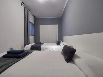 a bedroom with two beds and a window at Sagrada Familia Penthouse in Barcelona