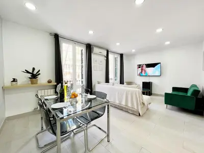a living room with a glass table and a bed at Sagrada Familia Gaudi in Barcelona
