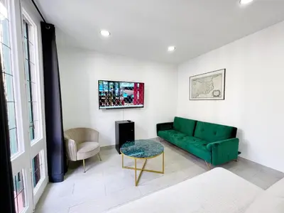 a living room with a green couch and a table at Sagrada Familia Gaudi in Barcelona