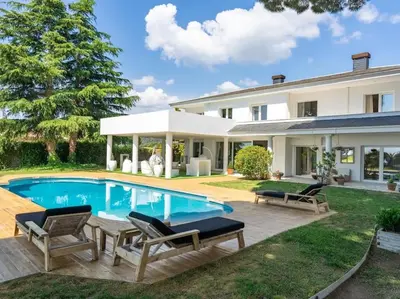 a backyard with a swimming pool and a house at Luxury Villa Buena Vista Pool and Garden in Arenys de Munt