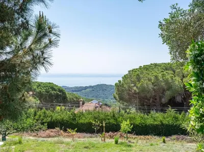 a view of the ocean from a garden at Luxury Villa Buena Vista Pool and Garden in Arenys de Munt
