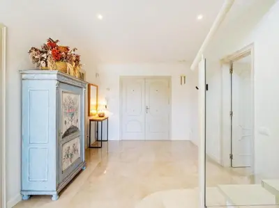 a hallway with a blue cabinet with flowers on top at Luxury Villa Buena Vista Pool and Garden in Arenys de Munt