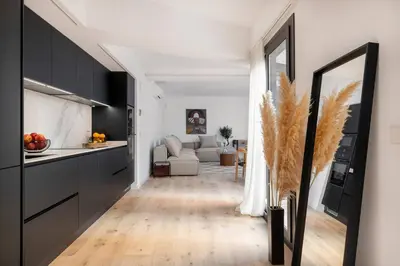 a kitchen and a living room with a couch at Luxury apartment in Barcelona City Center in Barcelona