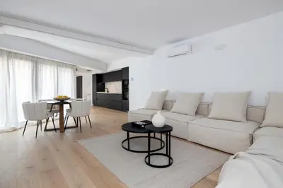 a living room with a white couch and a table at Luxury apartment in Barcelona City Center in Barcelona