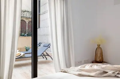 a bedroom with a bed and a view of a patio at Luxury apartment in Barcelona City Center in Barcelona
