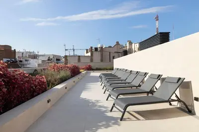 a row of chairs sitting on top of a building at Luxury apartment in Barcelona City Center in Barcelona