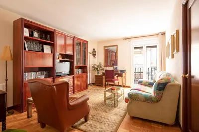 a living room with a couch a chair and a television at AB Paralel Blai Apartment in Barcelona