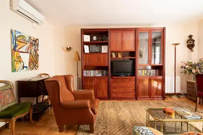 a living room with a chair and a television at AB Paralel Blai Apartment in Barcelona