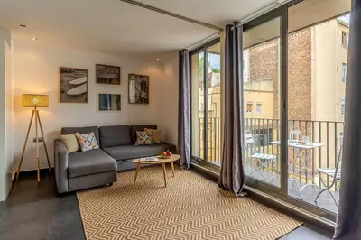 a living room with a couch and a balcony at 1802 - AB Poblenou Comfort in Barcelona
