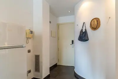 a hallway with a door and a bag on a wall at 1802 - AB Poblenou Comfort in Barcelona