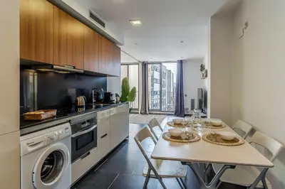 a kitchen with a table and a washer at 1802 - AB Poblenou Comfort in Barcelona