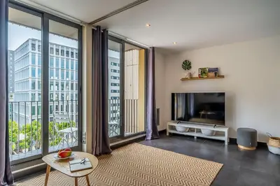 a living room with a tv and a large window at 1802 - AB Poblenou Comfort in Barcelona